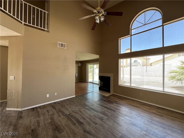 5128 Sandstone Dr, Las Vegas, NV 89142 - unfurnished living room with ceiling fan, baseboards, dark wood-type flooring, and a towering ceiling