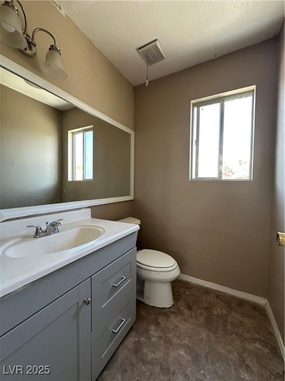 5128 Sandstone Dr, Las Vegas, NV 89142 - bathroom featuring vanity, toilet, and baseboards