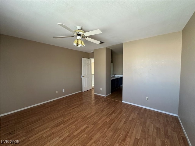 5128 Sandstone Dr, Las Vegas, NV 89142 - empty room featuring dark wood-style floors, baseboards, and ceiling fan