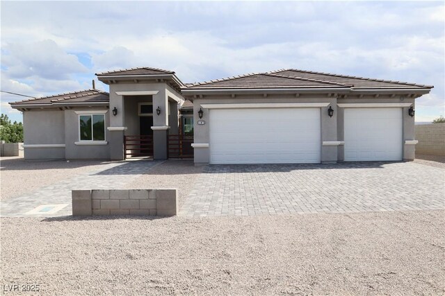 197 E Shelbourne Ave, Las Vegas, NV 89123 - prairie-style home with driveway, an attached garage, stucco siding, and a tiled roof