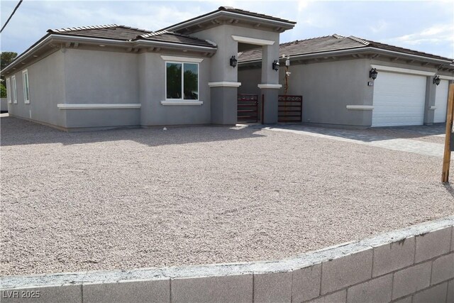 197 E Shelbourne Ave, Las Vegas, NV 89123 - view of front facade featuring a tiled roof, stucco siding, a garage, and driveway