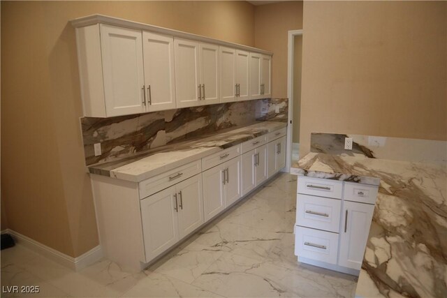 197 E Shelbourne Ave, Las Vegas, NV 89123 - kitchen with light marble finish flooring, tasteful backsplash, and white cabinetry
