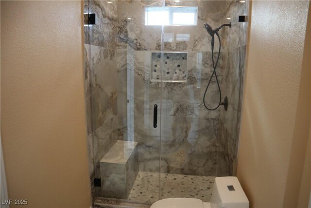 197 E Shelbourne Ave, Las Vegas, NV 89123 - bathroom featuring toilet, a marble finish shower, and a textured wall