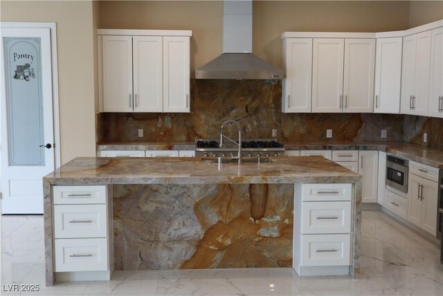 197 E Shelbourne Ave, Las Vegas, NV 89123 - kitchen featuring wall chimney range hood, light marble finish flooring, and backsplash