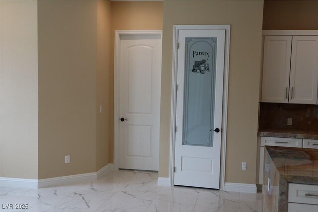197 E Shelbourne Ave, Las Vegas, NV 89123 - unfurnished dining area with light marble finish flooring and baseboards