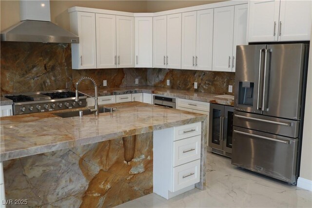 197 E Shelbourne Ave, Las Vegas, NV 89123 - kitchen with stainless steel appliances, wall chimney exhaust hood, beverage cooler, a sink, and light stone counters