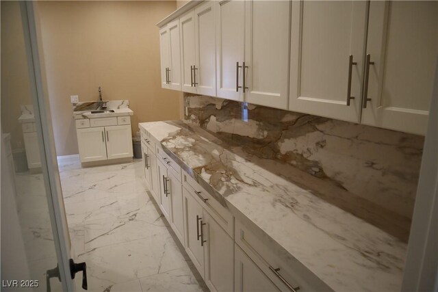 197 E Shelbourne Ave, Las Vegas, NV 89123 - laundry room with light marble finish flooring and a sink