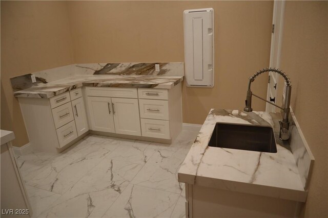 197 E Shelbourne Ave, Las Vegas, NV 89123 - laundry room with a sink, light marble finish flooring, electric panel, and baseboards