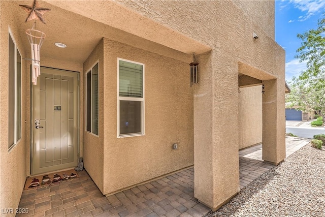 4212 Juanita May Ave, North Las Vegas, NV 89032 - doorway to property featuring stucco siding and a patio area