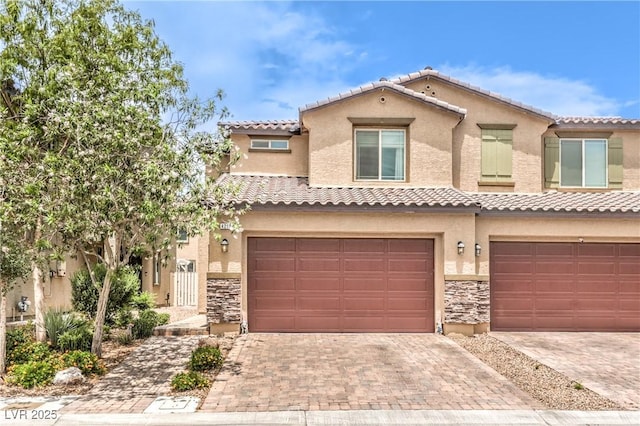 4212 Juanita May Ave, North Las Vegas, NV 89032 - view of front of house with a garage, stone siding, decorative driveway, and stucco siding