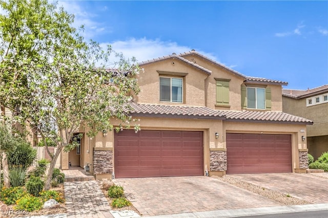 4212 Juanita May Ave, North Las Vegas, NV 89032 - view of front of house featuring stone siding, an attached garage, a tile roof, and decorative driveway