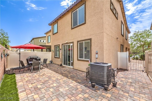 4212 Juanita May Ave, North Las Vegas, NV 89032 - back of property featuring stucco siding, central air condition unit, a gate, a fenced backyard, and a patio area