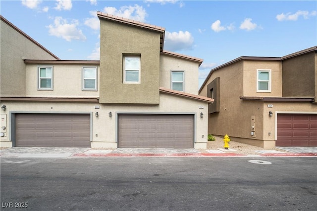 9929 Bumblebee Hills St, Las Vegas, NV 89141 - view of property with stucco siding and an attached garage