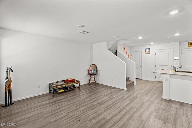 9929 Bumblebee Hills St, Las Vegas, NV 89141 - living area with light wood-type flooring, recessed lighting, stairway, and baseboards
