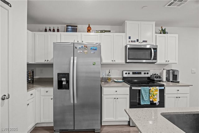 9929 Bumblebee Hills St, Las Vegas, NV 89141 - kitchen with appliances with stainless steel finishes and white cabinets