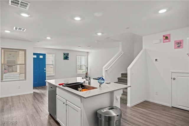 9929 Bumblebee Hills St, Las Vegas, NV 89141 - kitchen with dishwasher, a sink, light wood-style flooring, light countertops, and baseboards