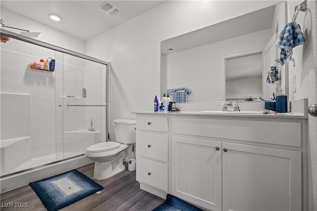9929 Bumblebee Hills St, Las Vegas, NV 89141 - full bathroom featuring wood finished floors, toilet, a stall shower, and vanity