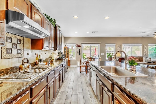 10420 Loma Portal Ave, Las Vegas, NV 89166 - kitchen featuring ventilation hood, a sink, recessed lighting, tasteful backsplash, and baseboards