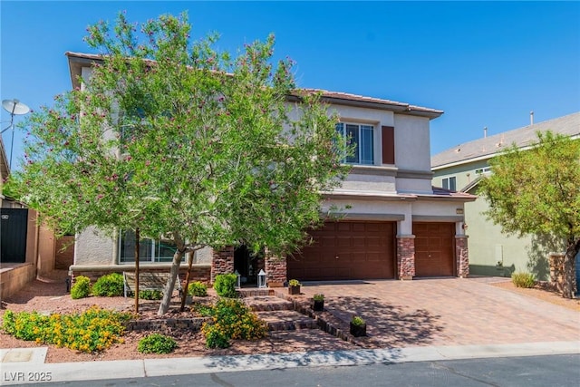 10420 Loma Portal Ave, Las Vegas, NV 89166 - obstructed view of property with an attached garage, stucco siding, and decorative driveway