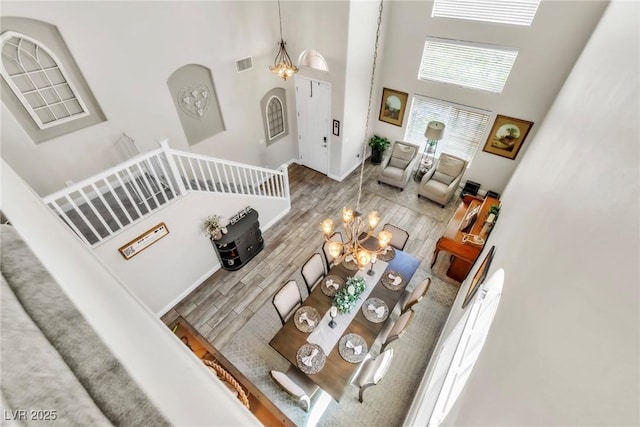 10420 Loma Portal Ave, Las Vegas, NV 89166 - living room with a chandelier, a high ceiling, and wood finished floors