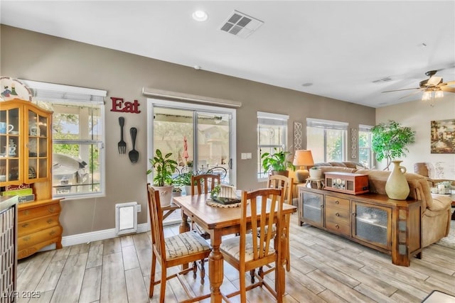 10420 Loma Portal Ave, Las Vegas, NV 89166 - dining area with light wood finished floors, a ceiling fan, plenty of natural light, and baseboards
