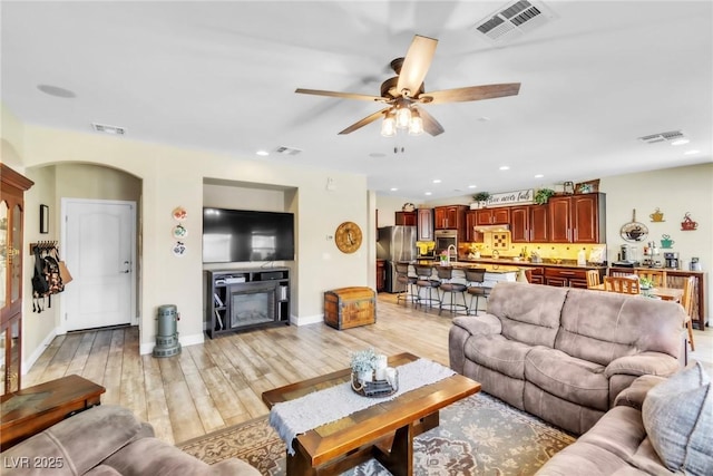 10420 Loma Portal Ave, Las Vegas, NV 89166 - living area featuring a ceiling fan, light wood-type flooring, baseboards, recessed lighting, and arched walkways