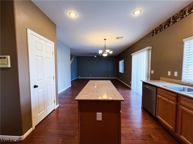 3412 Catherine Mermet Ave, North Las Vegas, NV 89081 - kitchen with dishwasher, a chandelier, a center island, open floor plan, and dark wood-style flooring
