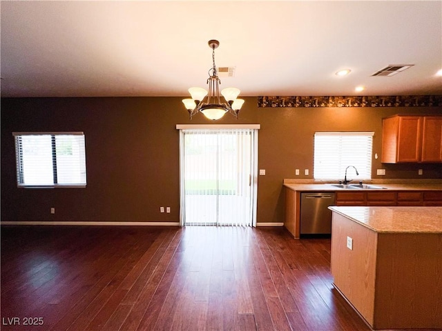 3412 Catherine Mermet Ave, North Las Vegas, NV 89081 - kitchen with stainless steel dishwasher, a sink, a chandelier, dark wood-type flooring, and plenty of natural light