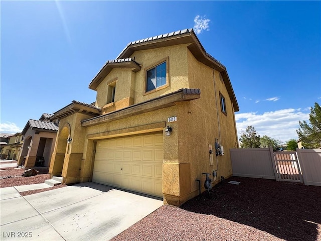 3412 Catherine Mermet Ave, North Las Vegas, NV 89081 - view of front facade with stucco siding, driveway, a garage, and a gate