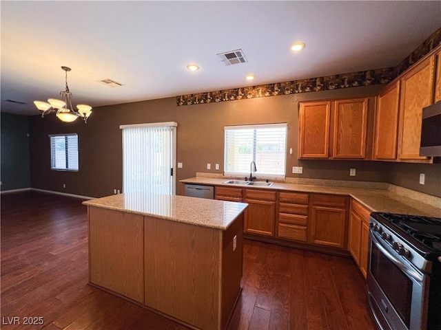 3412 Catherine Mermet Ave, North Las Vegas, NV 89081 - kitchen featuring a sink, stainless steel appliances, a center island, a chandelier, and dark wood-style flooring