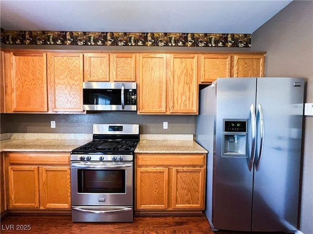 3412 Catherine Mermet Ave, North Las Vegas, NV 89081 - kitchen featuring appliances with stainless steel finishes, dark wood-style floors, and light stone counters