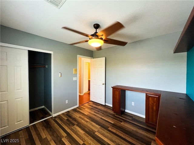 3412 Catherine Mermet Ave, North Las Vegas, NV 89081 - unfurnished bedroom with dark wood-style floors, baseboards, ceiling fan, and a closet