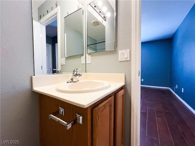 3412 Catherine Mermet Ave, North Las Vegas, NV 89081 - bathroom with wood finished floors, vanity, a textured wall, and baseboards