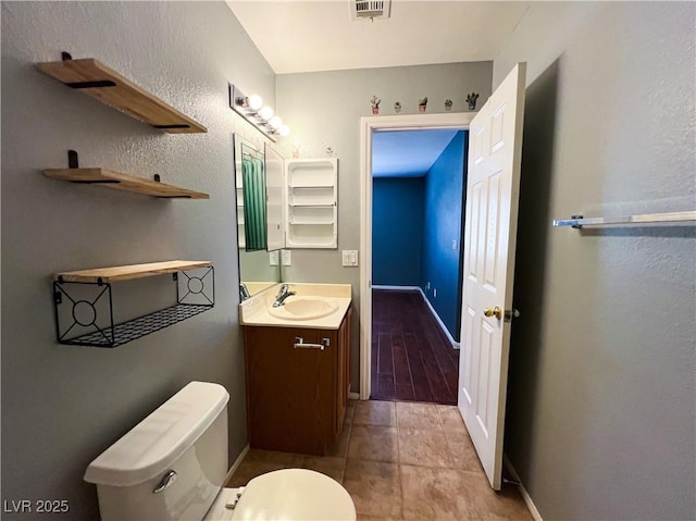 3412 Catherine Mermet Ave, North Las Vegas, NV 89081 - bathroom featuring vanity, toilet, baseboards, and tile patterned flooring