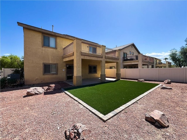 3412 Catherine Mermet Ave, North Las Vegas, NV 89081 - back of property with a balcony, stucco siding, and a patio area