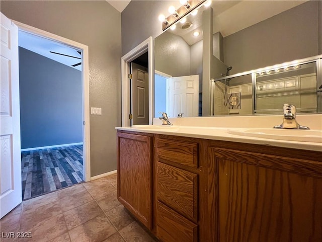 3412 Catherine Mermet Ave, North Las Vegas, NV 89081 - bathroom featuring double vanity, an enclosed shower, and baseboards