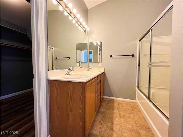 3412 Catherine Mermet Ave, North Las Vegas, NV 89081 - bathroom with double vanity, shower / bath combination with glass door, and baseboards
