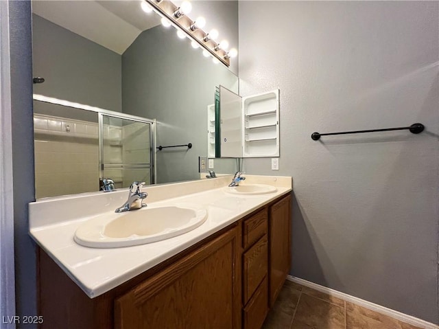 3412 Catherine Mermet Ave, North Las Vegas, NV 89081 - bathroom featuring double vanity, baseboards, an enclosed shower, and tile patterned floors