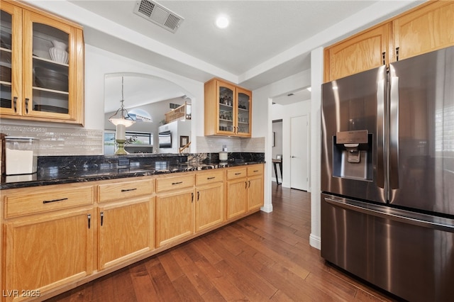 8780 Autumn Wreath Ave, Las Vegas, NV 89129 - kitchen featuring stainless steel refrigerator with ice dispenser, tasteful backsplash, dark wood-style flooring, glass insert cabinets, and dark stone countertops