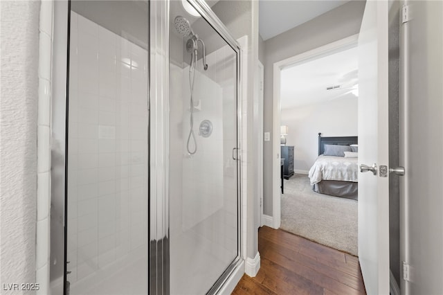 8780 Autumn Wreath Ave, Las Vegas, NV 89129 - ensuite bathroom featuring wood finished floors, a stall shower, and baseboards