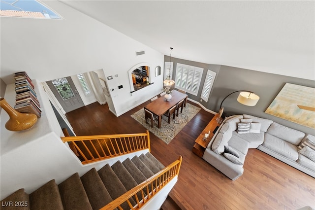 8780 Autumn Wreath Ave, Las Vegas, NV 89129 - living area with wood finished floors, high vaulted ceiling, and stairway