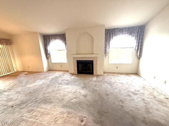 7570 W Flamingo Rd Unit 202, Las Vegas, NV 89147 - unfurnished living room with a tile fireplace and carpet