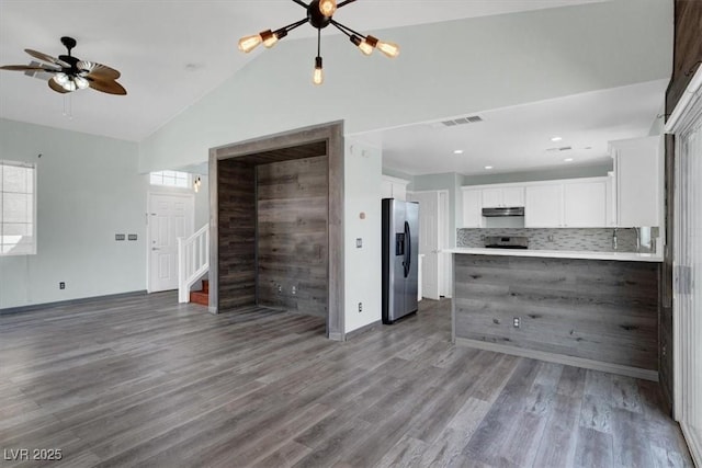 8389 Charlton Valley Ct, Las Vegas, NV 89123 - unfurnished living room with vaulted ceiling, stairway, plenty of natural light, wood finished floors, and ceiling fan