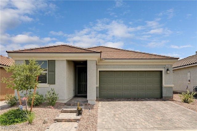 4293 Nopal Serrano Ave, Las Vegas, NV 89141 - view of front facade featuring decorative driveway, a garage, a tile roof, and stucco siding