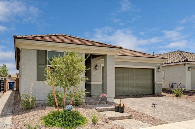 4293 Nopal Serrano Ave, Las Vegas, NV 89141 - view of front of property with an attached garage, decorative driveway, a tile roof, and stucco siding