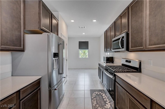 4293 Nopal Serrano Ave, Las Vegas, NV 89141 - kitchen with stainless steel appliances, dark brown cabinetry, light countertops, and recessed lighting