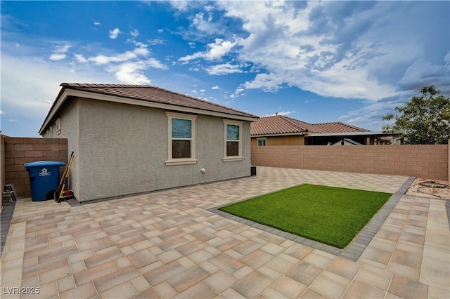 4293 Nopal Serrano Ave, Las Vegas, NV 89141 - back of house with a fenced backyard, a patio area, stucco siding, and a tile roof