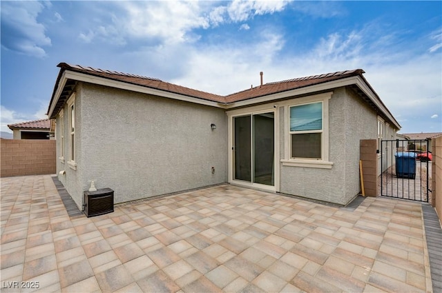 4293 Nopal Serrano Ave, Las Vegas, NV 89141 - rear view of property featuring a gate, stucco siding, a patio area, and a tiled roof