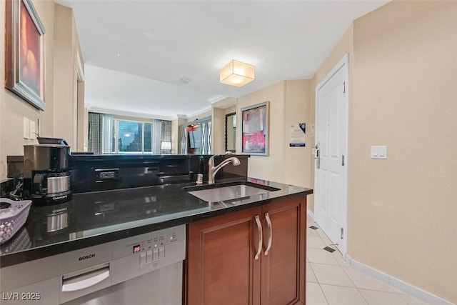 135 E Harmon Ave Unit 1401, Las Vegas, NV 89109 - kitchen featuring a sink, dishwashing machine, brown cabinetry, baseboards, and light tile patterned flooring