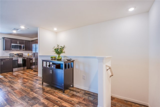 6819 Citron Mist Ct, North Las Vegas, NV 89086 - kitchen featuring appliances with stainless steel finishes, dark wood-type flooring, dark brown cabinets, baseboards, and recessed lighting